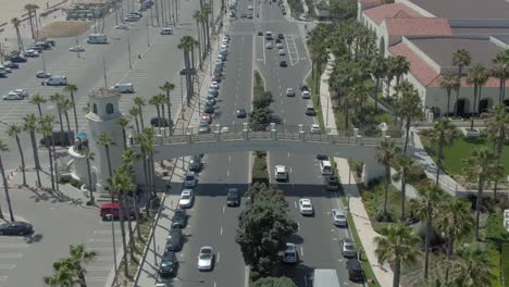 Drone-flying-towards-Huntington-Beach-cross-walk-bridge-on-PCH