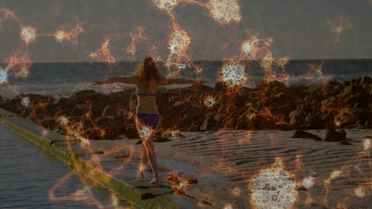 female beachgoer balancing on jetty under sunlight, with glowing starburst overlays for health ad