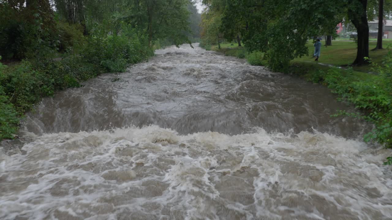 Stranger walking by the strong current of river