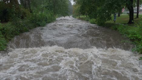 stranger walking by the strong current of river