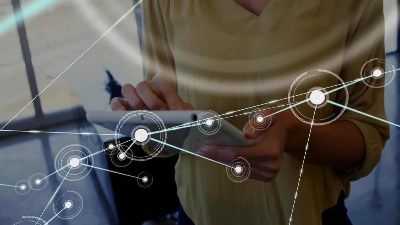 woman tapping tablet inside modern office, showing technology network nodes and data visualization