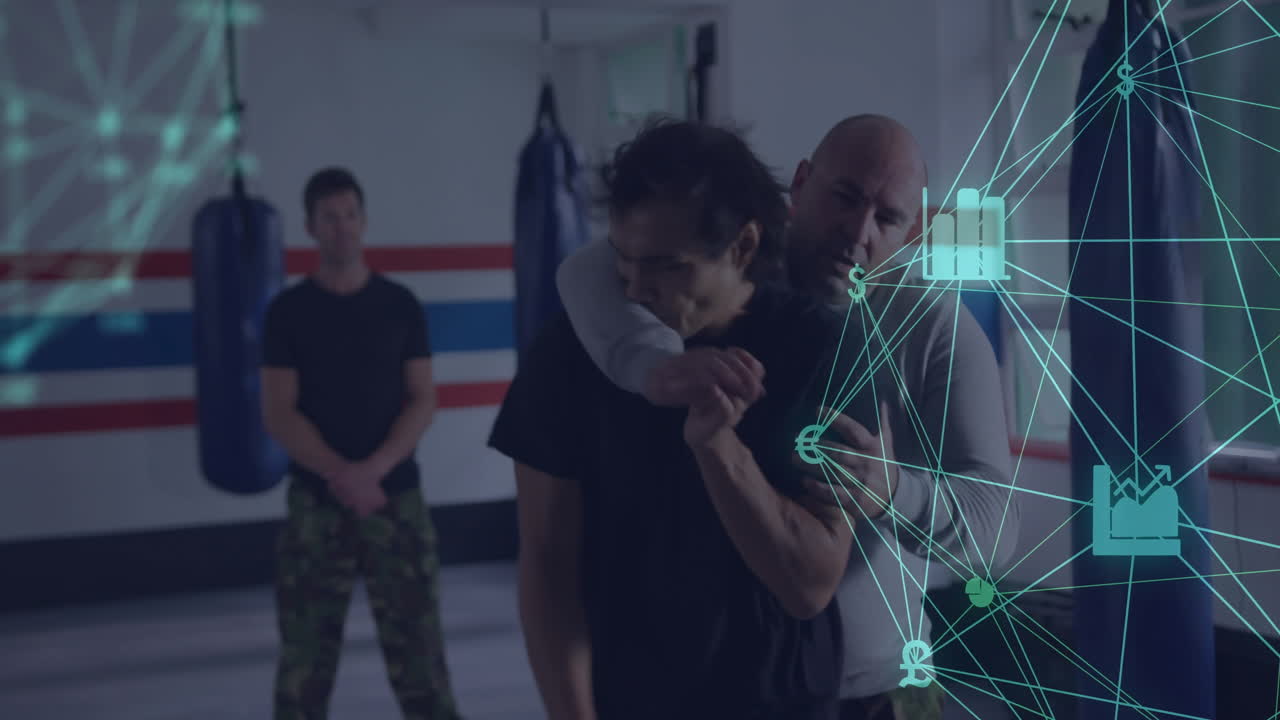 Instructor demonstrating rear naked choke on trainee in gym, showing finance chart money icons