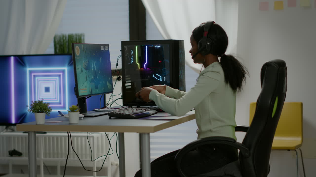 Winner black gamer sitting on gaming chair playing space shooter