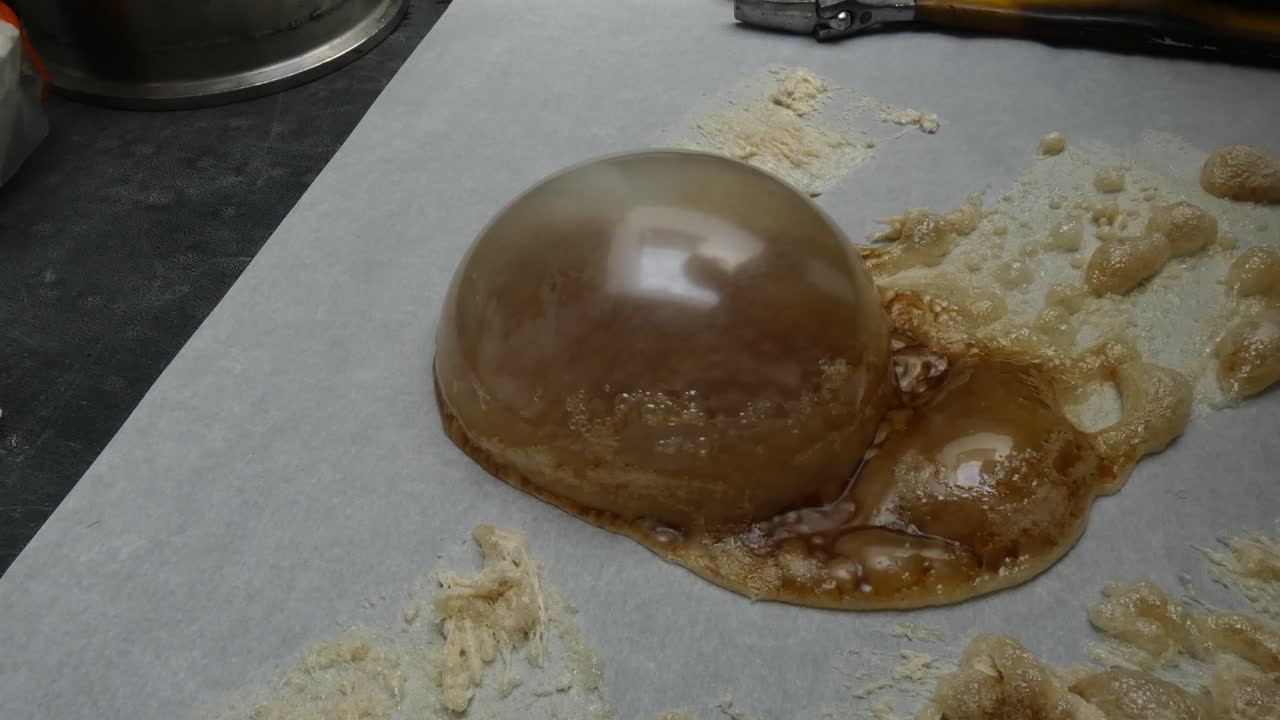 During the process of making cannabis concentrate, BHO or butane hash oil, a very large bubble of wax forms on the parchment paper.