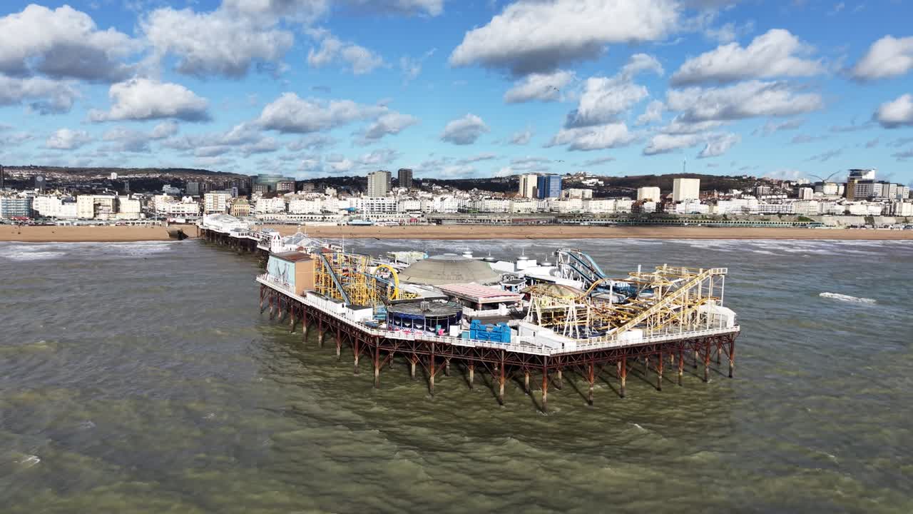 Brighton pier sunny day fluffy white clouds in background drone,aerial reverse