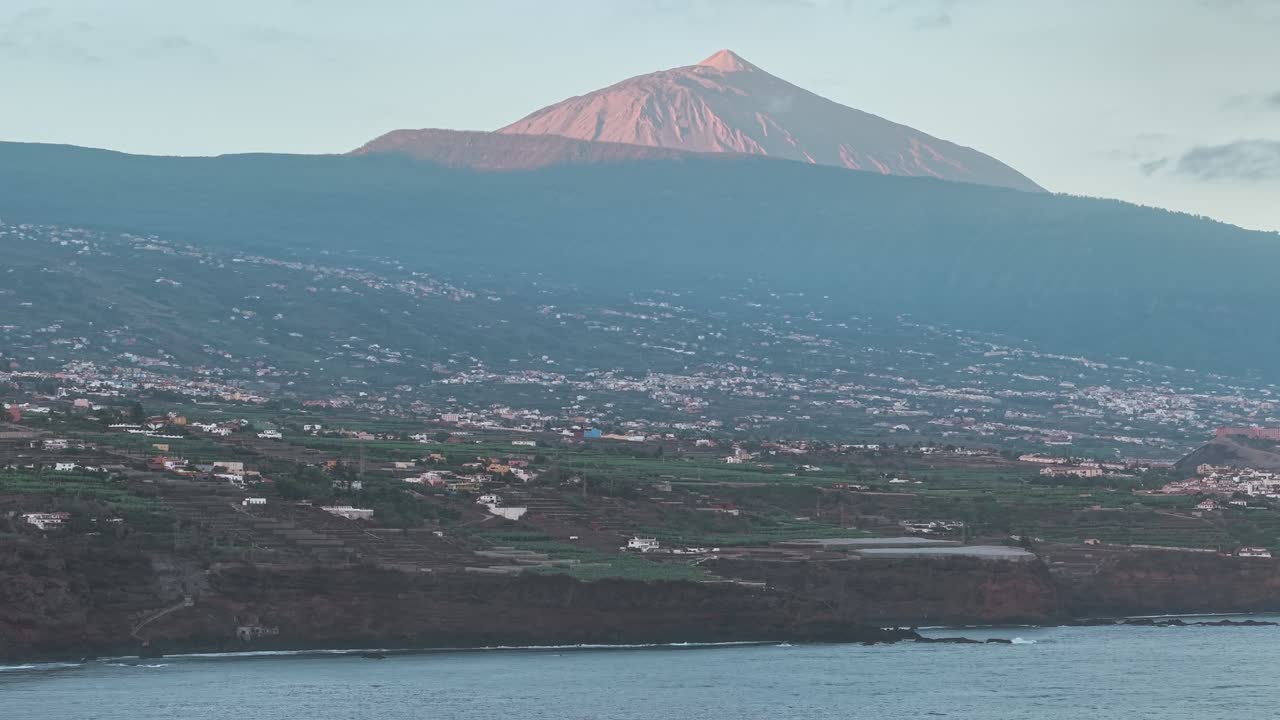 aerial view of Mount Teide volcano overlooking green coast of Tenerife