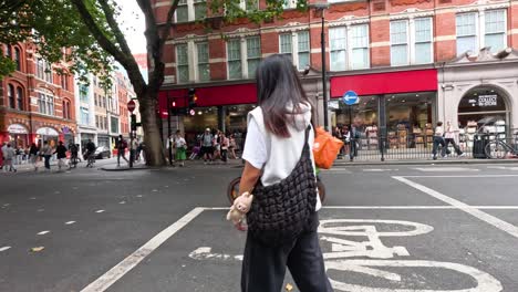 pedestrians and cyclists at a bustling city intersection