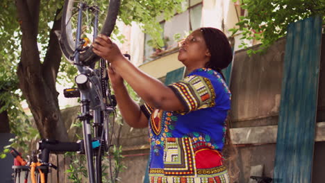 young woman securing bicycle wheel