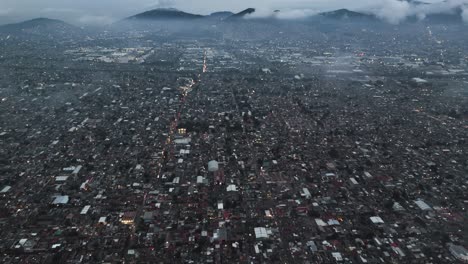 Drone's aerial views of low clouds over Ecatepec in afternoon