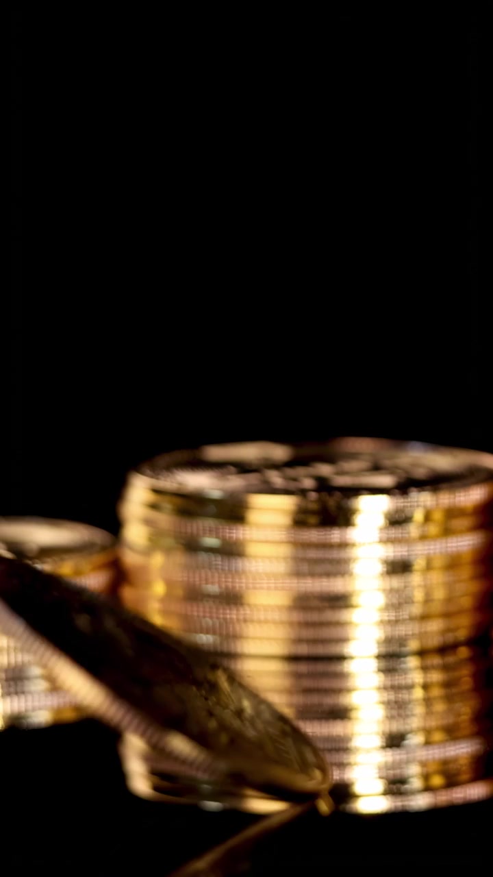 Gold Bitcoin Coin Spinning on Reflective Surface