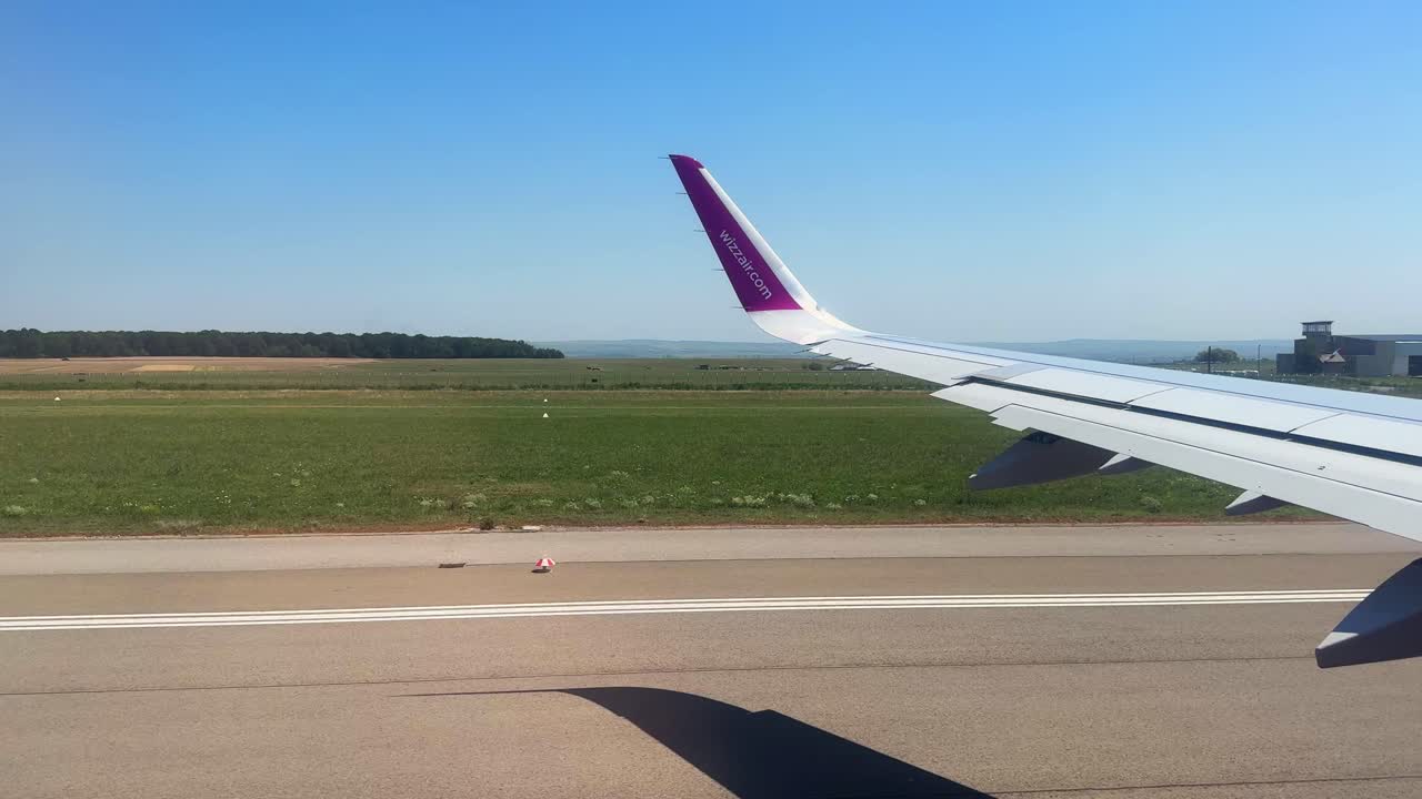 Plane window view takeoff Suceava Airport in Romania, fly airplane wing view