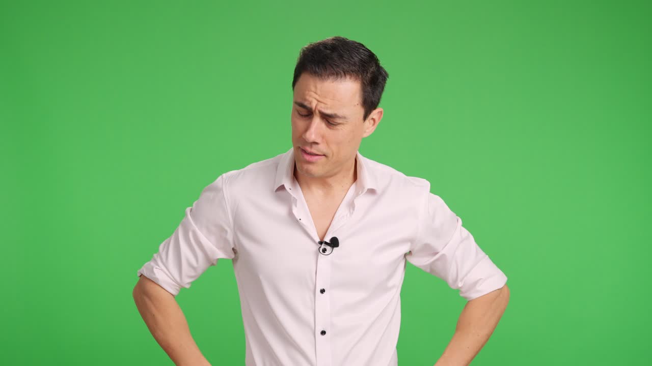 Journalist attaching lavalier microphone on green screen