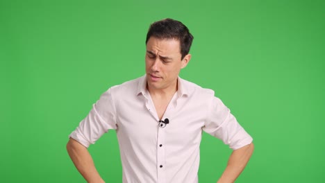 journalist attaching lavalier microphone on green screen