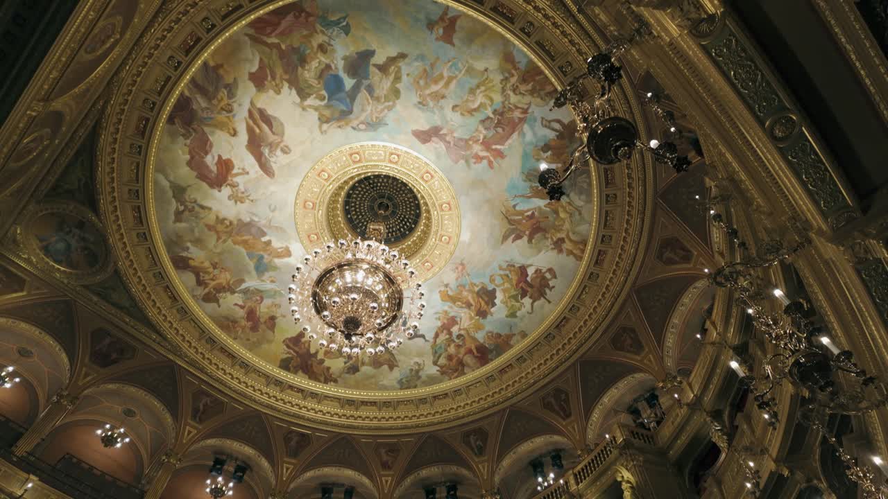 Tilt up to ornate gilded dome ceiling in Hungarian State Opera House