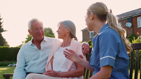 nurse talking to senior couple in residential care home