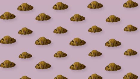 colorful pattern of croissants on pink background. seamless pattern with croissant. top view. realistic animation. 4k video motion