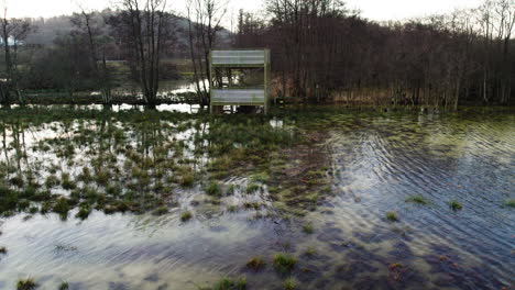 Flooded-Field-with-Birdwatching-Tower-in-Sweden---Aerial-Shot