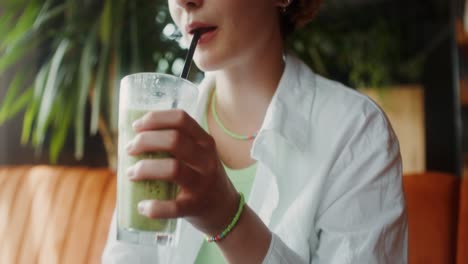 young woman enjoying a smoothie in a cafe