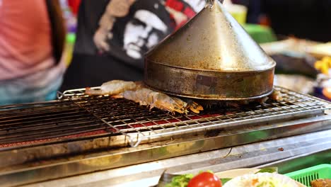 seafood grilling process at a bustling night market