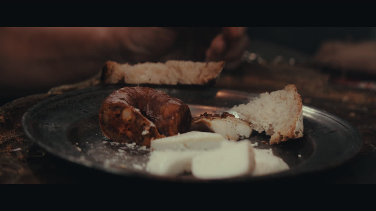 An old pirate eats and drinks inside the sailing ship cabin