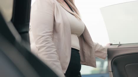 view of woman exiting car seen from inside the vehicle