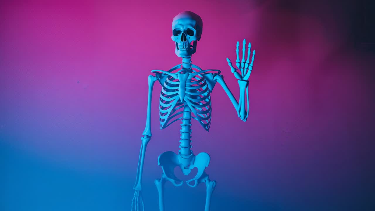 Starting skeleton model lifting right hand in wave in studio, with colored lights and haze