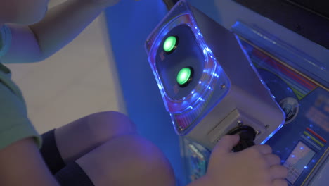 boy playing sea battle video game in amusement park