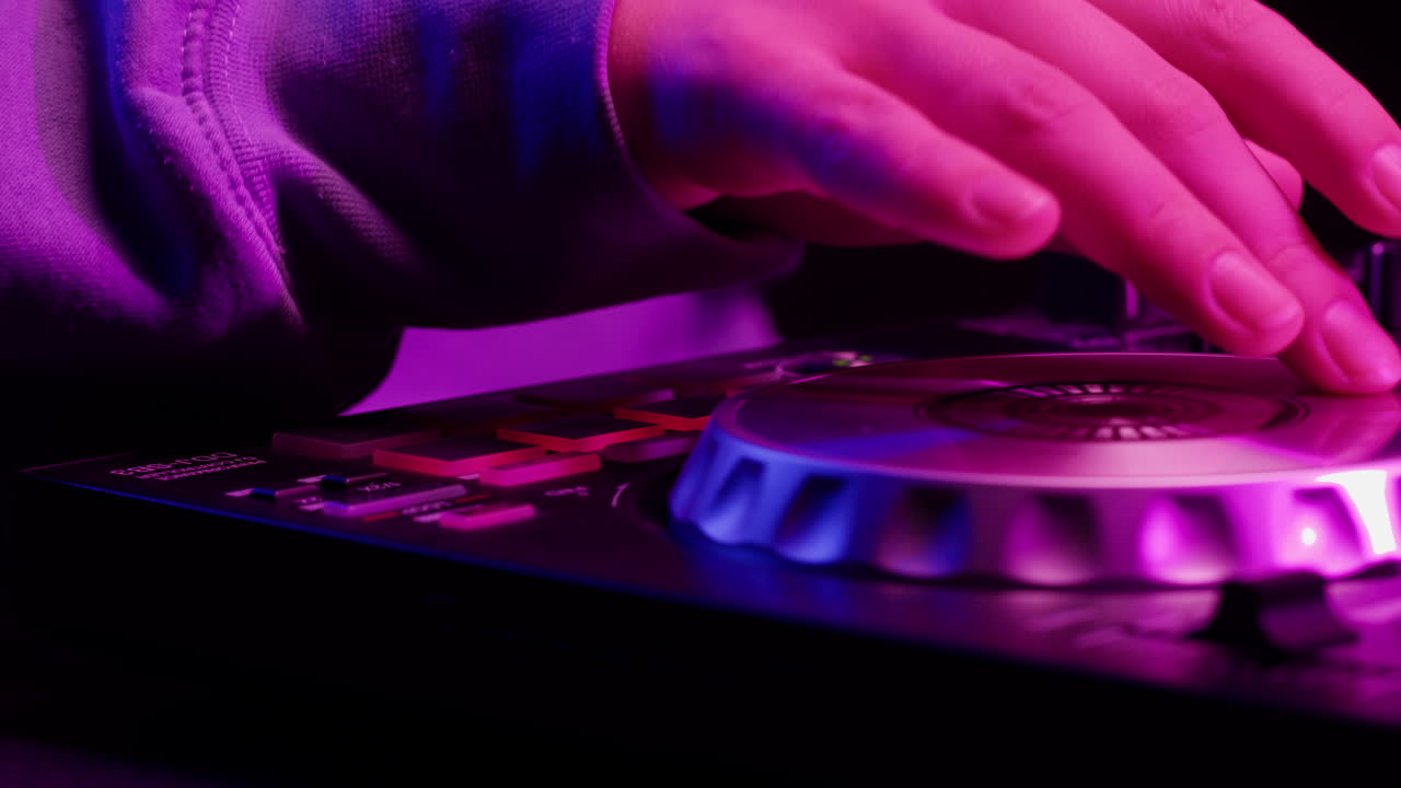 DJ with headphones and sunglasses playing music on festival in night club. Techno musician performing at nightclub for concert crowd of people, city bar.