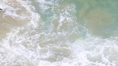 dynamic ocean waves meeting sandy beach