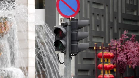 Pedestrian-Crosswalk-Sign-Bukit-Bintang,-Kuala-Lumpur,-Malaysia-Traffic-Light-Illuminated-Walker-Icon-From-Green-to-Red