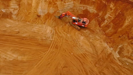 aerial view of crawler excavator standing on sand mine. sand mining
