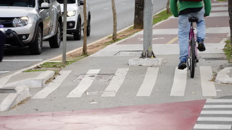 bicycles riding in the bike lane in the center of a busy street of a big city