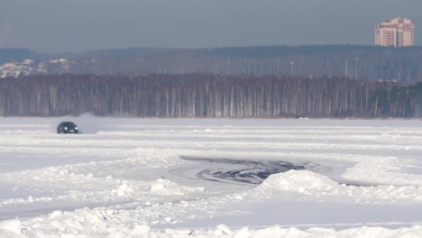 car driving on frozen lake in winter landscape