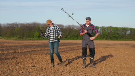 farmers planting trees in a field