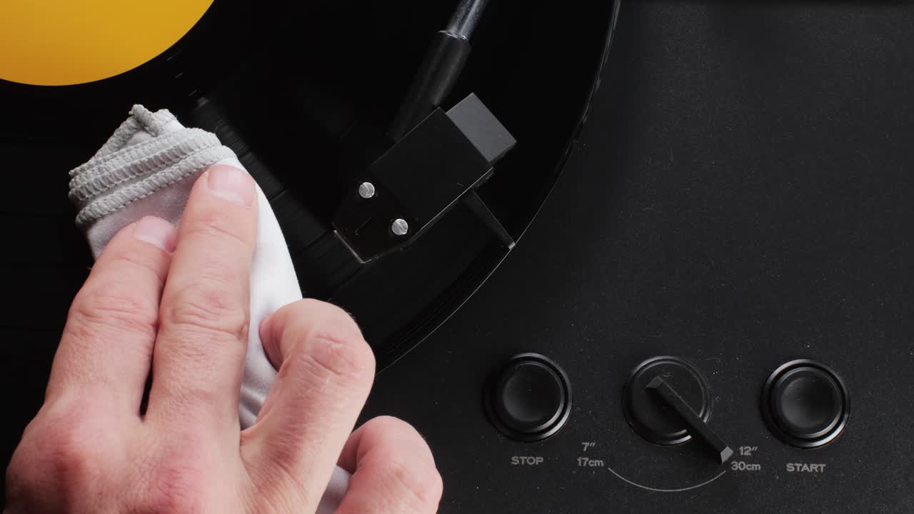 Retro Vinyl record player playing music, close-up macro shot of vintage LP disc old phonograph spinning. Retro music player.