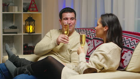 Zoom-in-shot-of-couple-holding-glasses-of-champagne