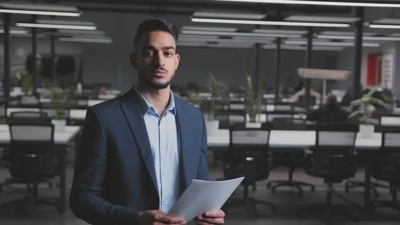 Confident middle eastern businessman wearing suit posing at modern office, , tracking shot, empty space