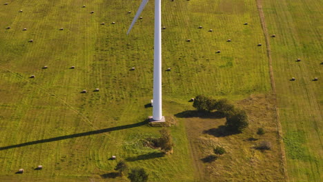 wind mills at the farmlands in kurzeme region, latvia. aerial tilt-up shot