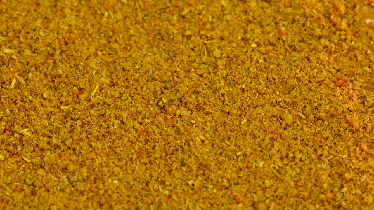 Curry in polvere che cade e ricopre lo sfondo bianco