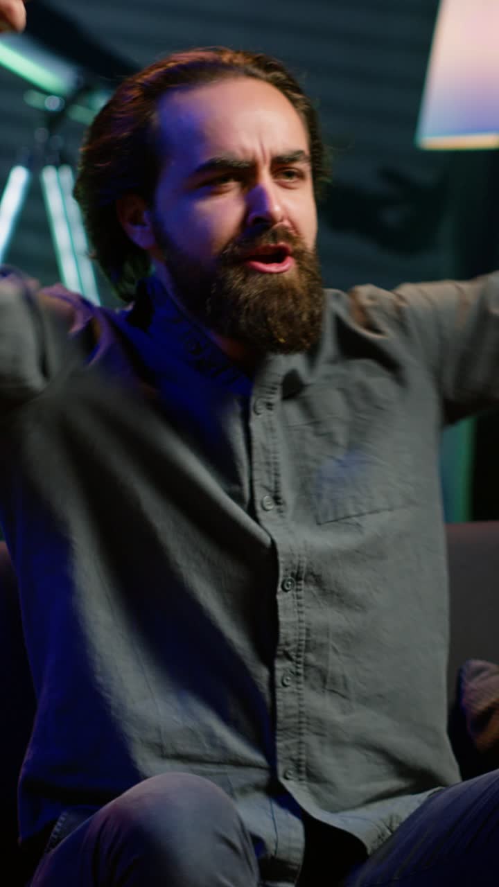 Vertical video Fan watching live sports event on TV, chanting for team, having fun