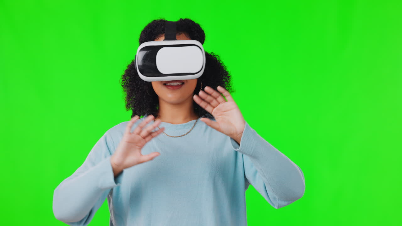 Happy woman on green screen with VR headset