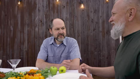 two men sitting and talking before having dinner