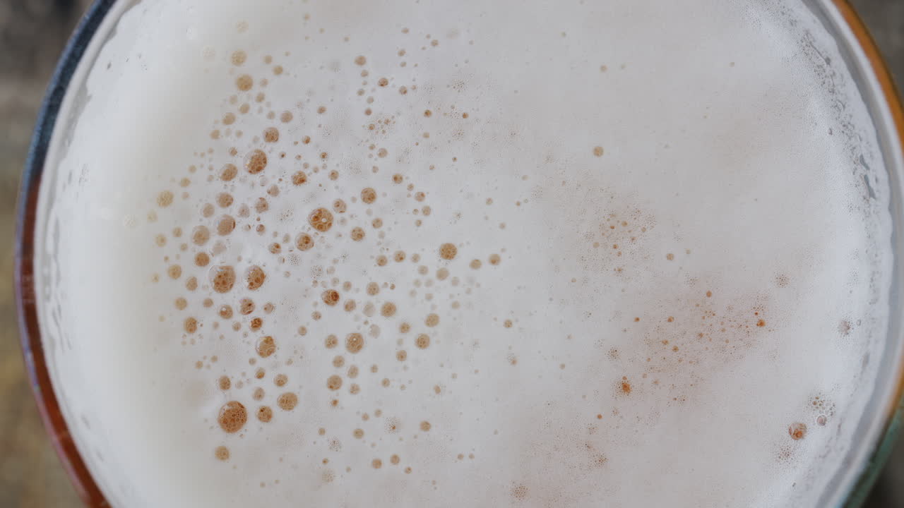Close up of the foam at the top of a beer glass