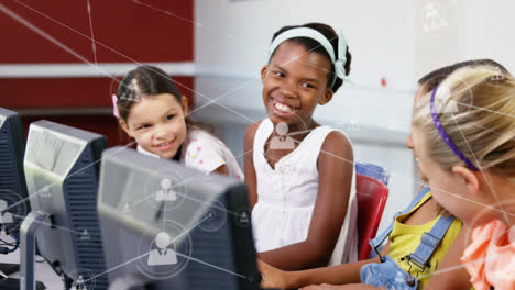 network of profile icons against group of diverse girls using computer at school