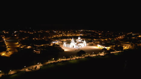 Drone over the beautiful El Rocio town. The bright white church lights up the night