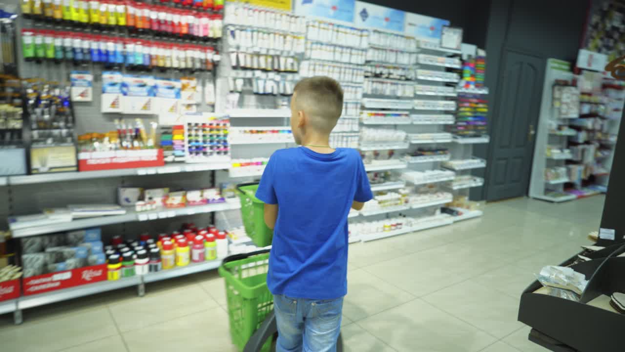 VINNITSA, UKRAINE - AUGUST 20, 2018: Back to School. Boy choosing school stationery at the supermarket.