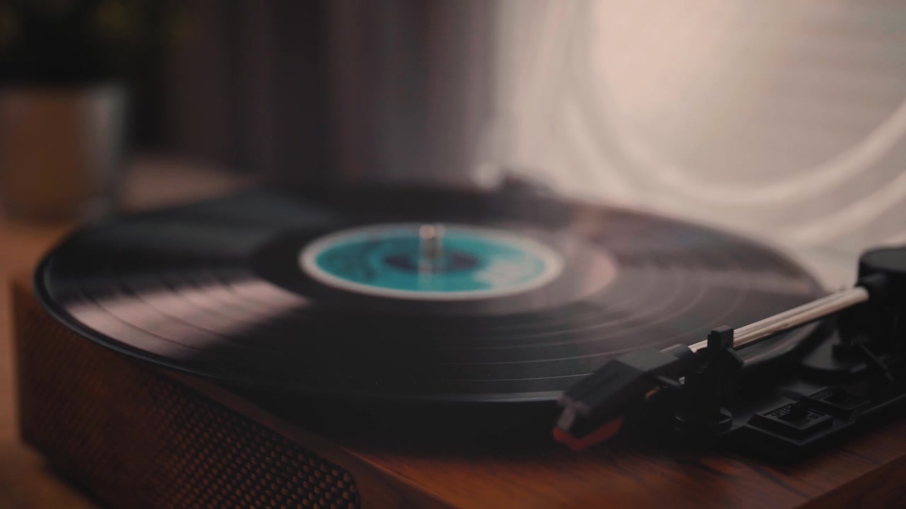 Persona che posiziona un disco in vinile su un classico giradischi in legno