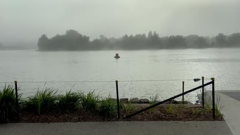 Thick-fog-cover-Sydney-skyline,-cinematic,-dramatic-scene-of-foggy-and-windy-day-by-the-river