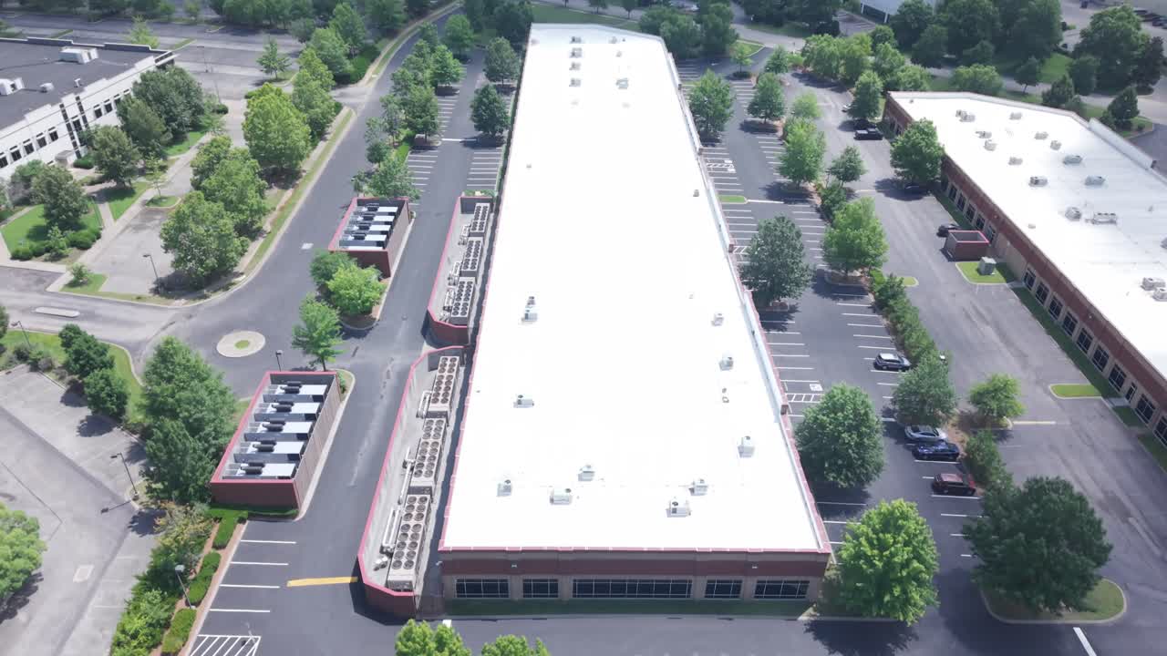 Aerial view of a commercial property with a large parking lot