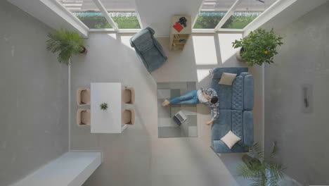 working at home, man sitting on carpet